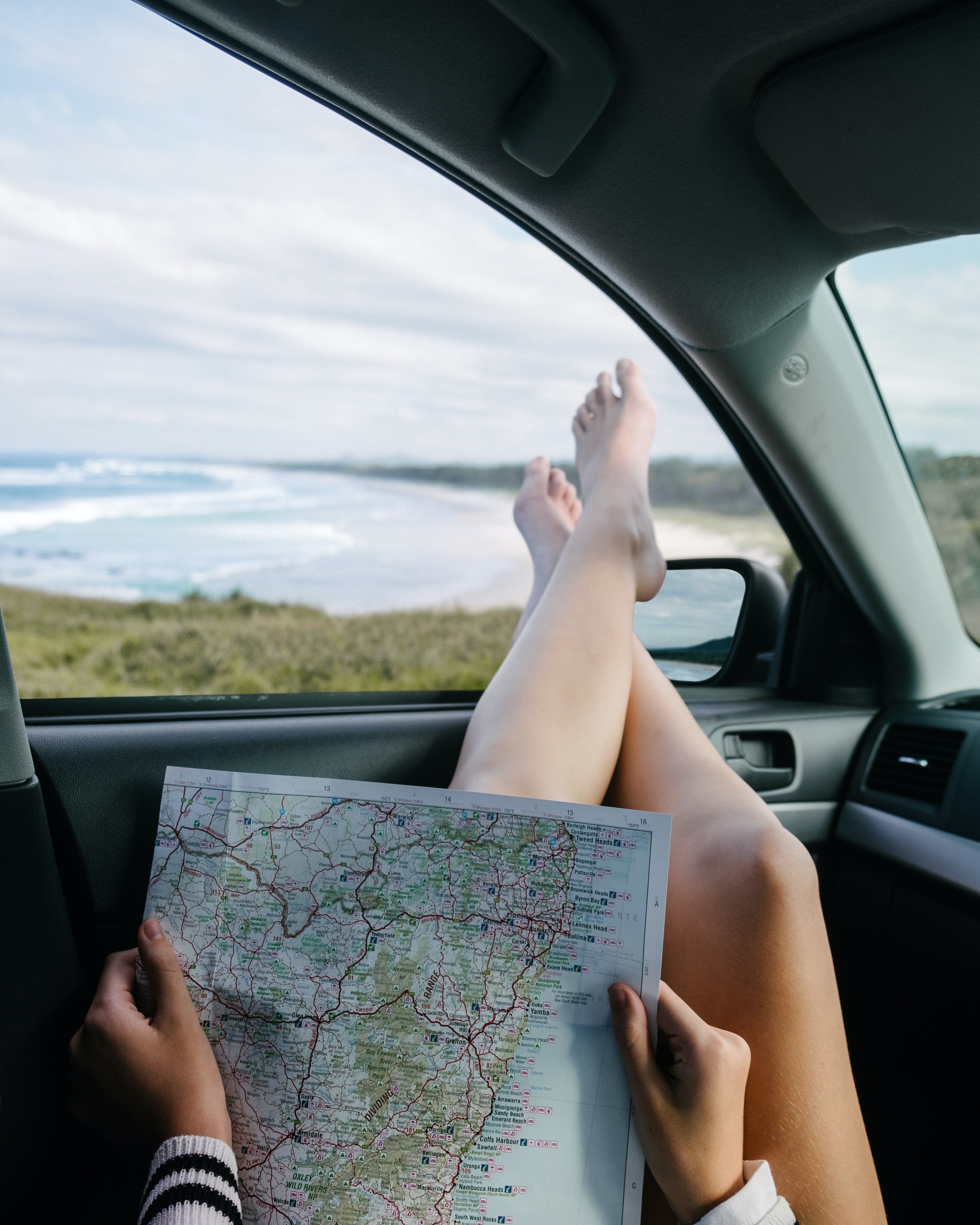 woman looks at map to prepare for a long car trip