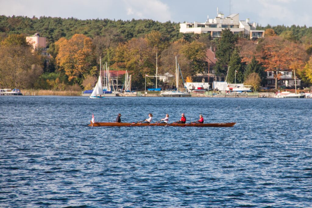 people rowing on long canoe in Wannsee, Germany