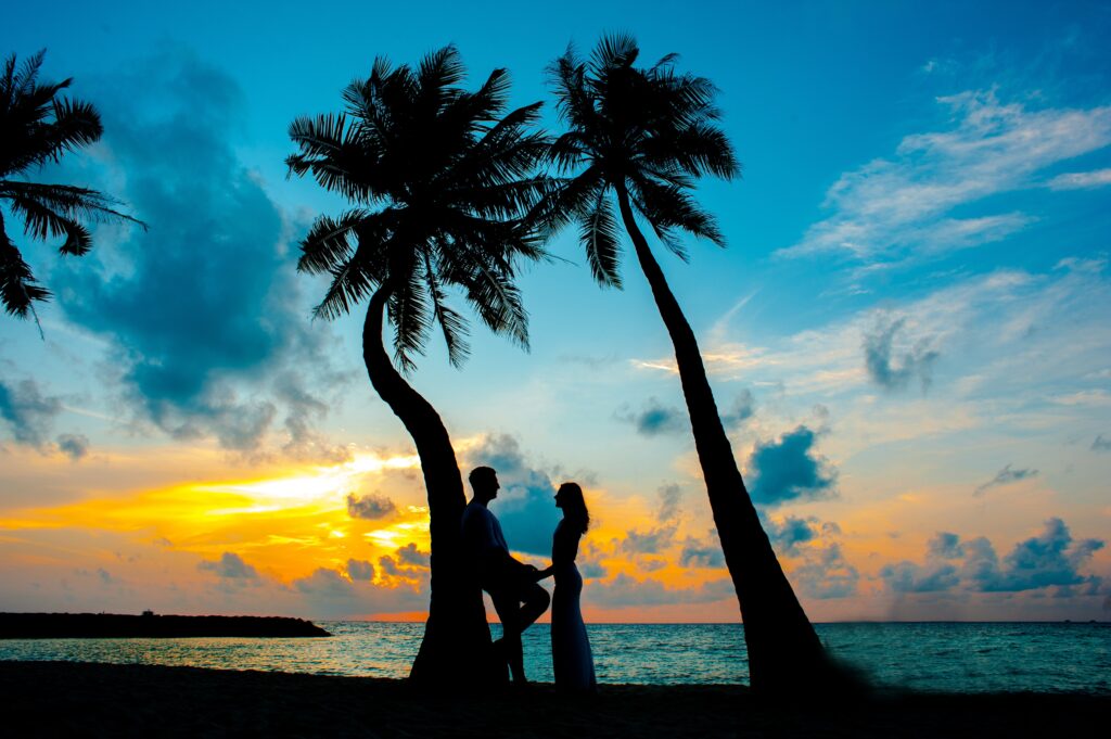 couple under a tree in the Maldives on romantic getaways together