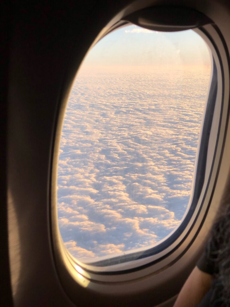 view from plane window into the clouds on post about stress free traveling