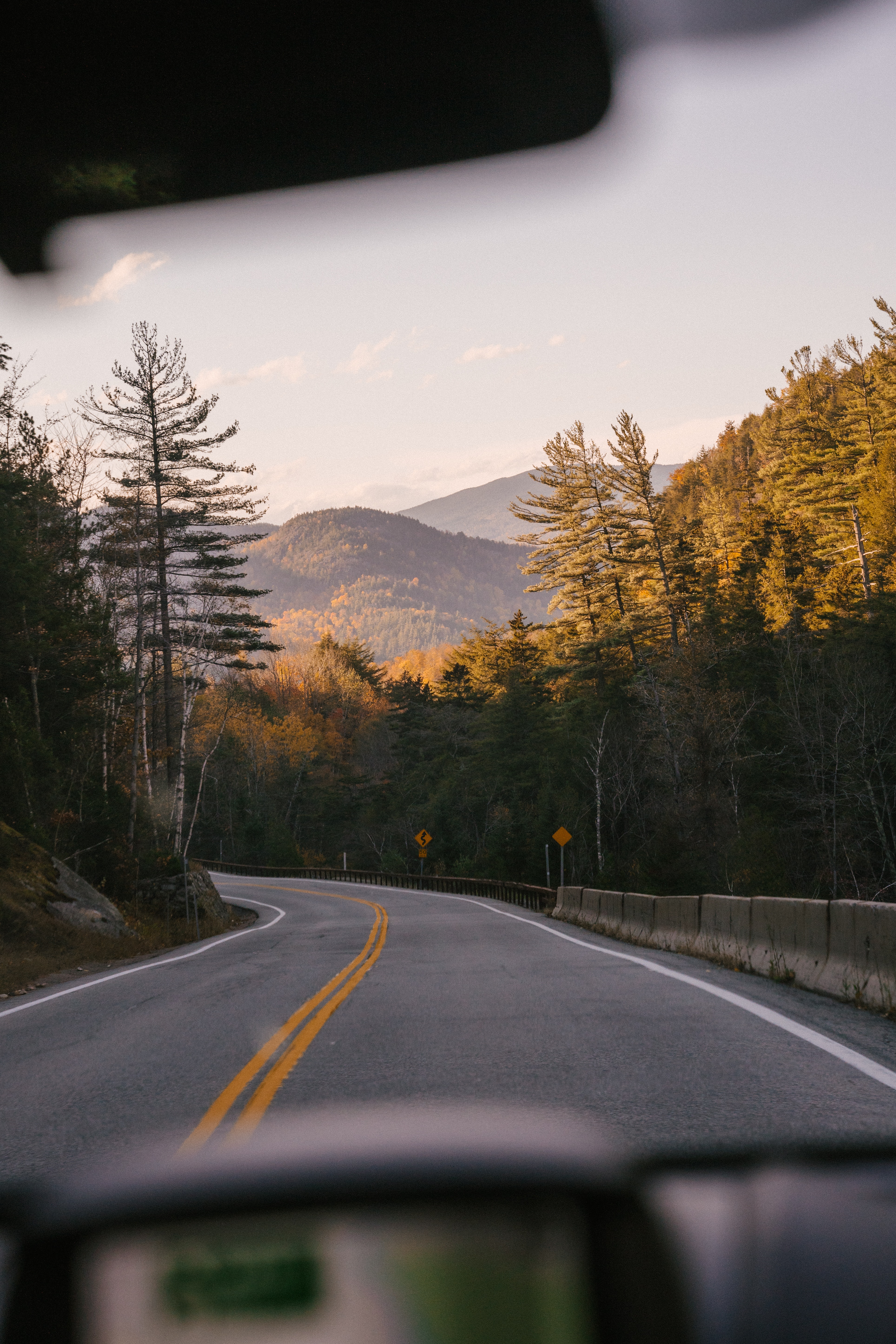 car going down road with dashboard view for post on pros and cons of solo travel