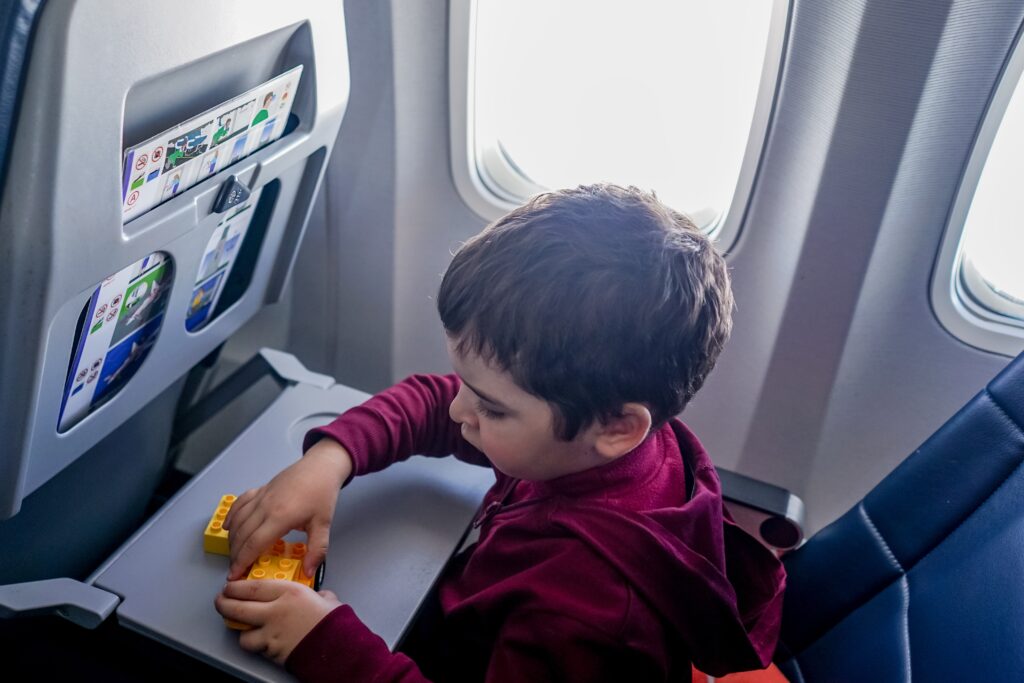 boy playing with Legos on plane for stress free traveling