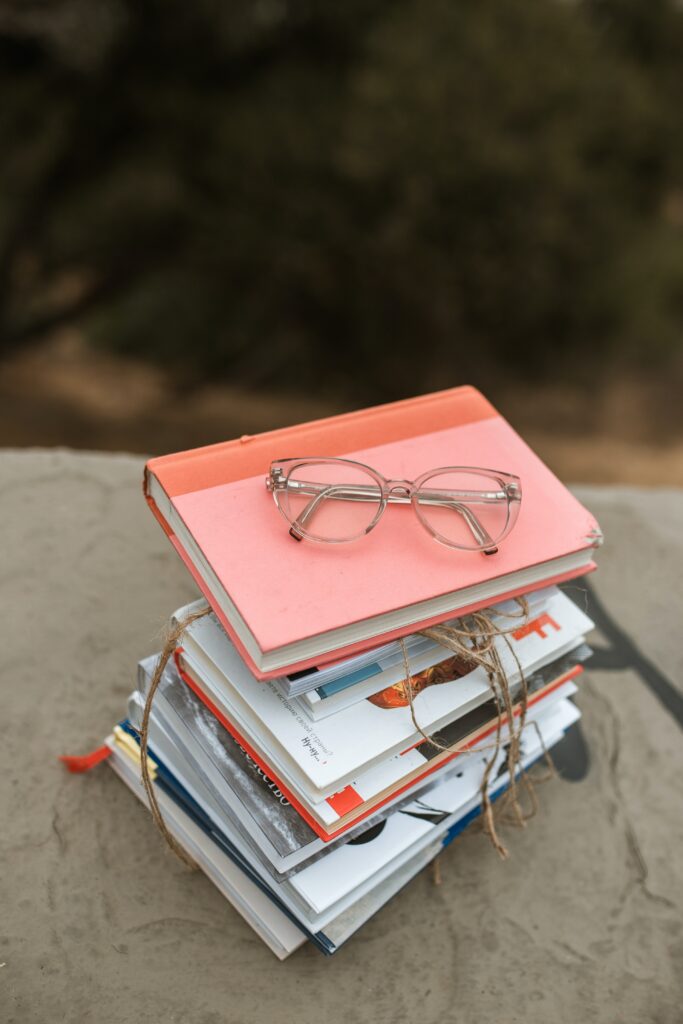 stack of book of German learning resources with glasses on top