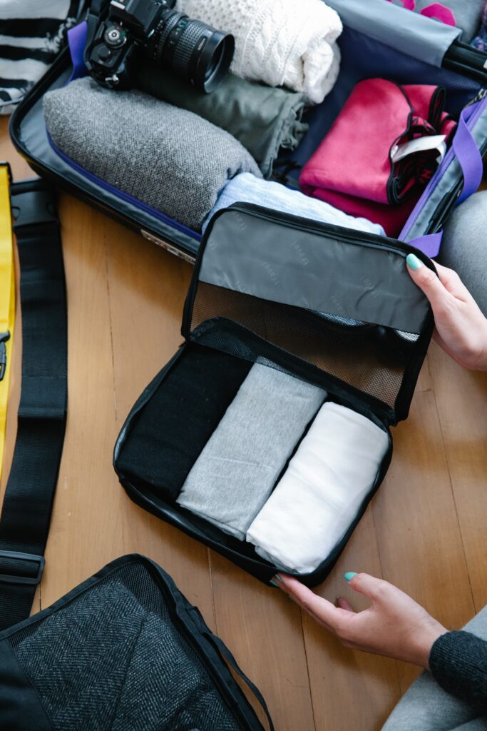 woman packing suitcase organizers for luggage